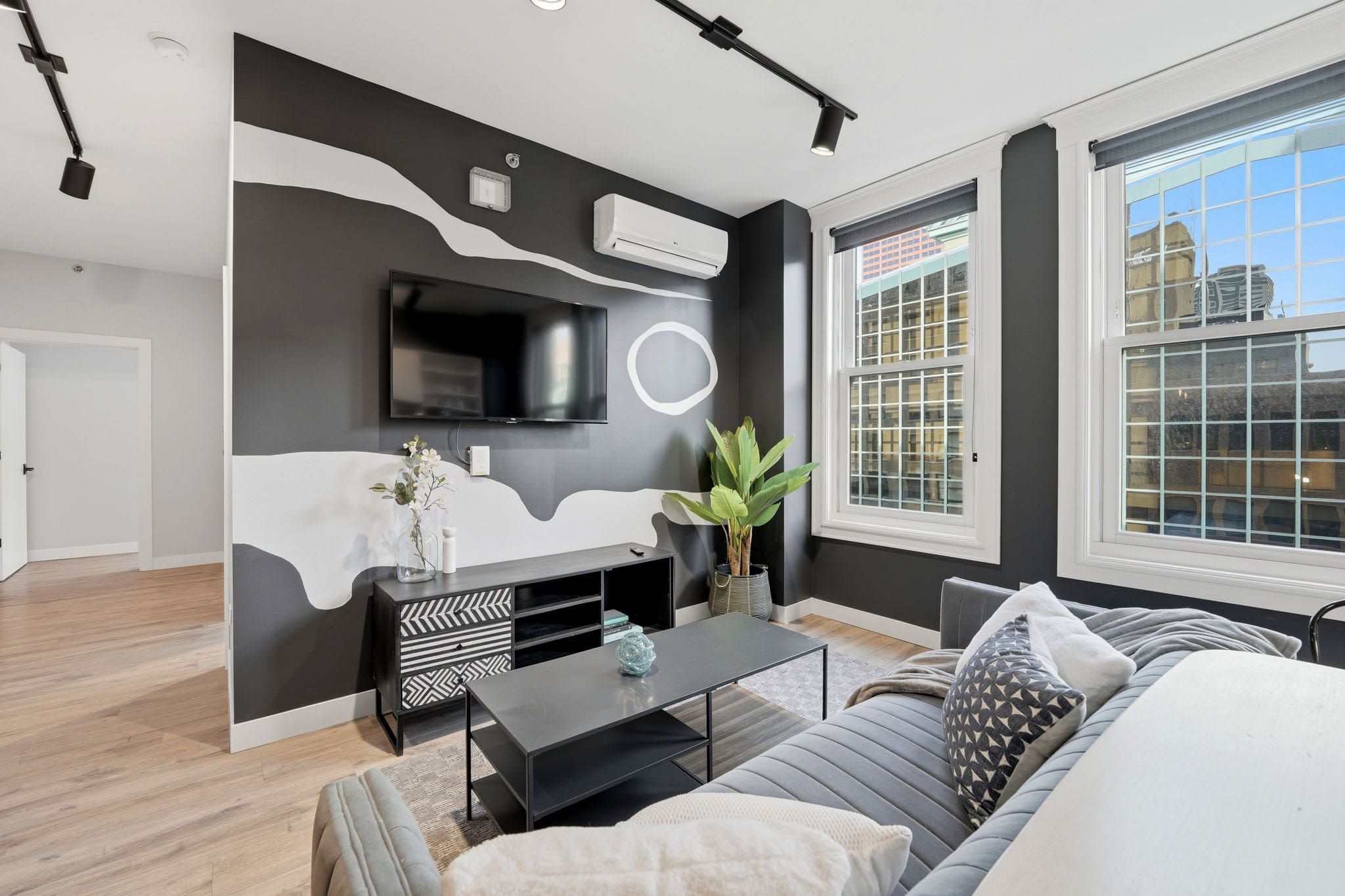 Top-floor four-bedroom suite living room with a black and white mural wall